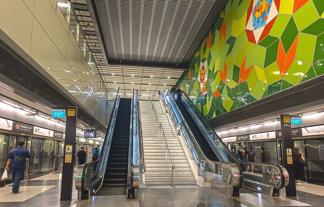 Escalators and mosaic art wall at Woodlands South MRT station